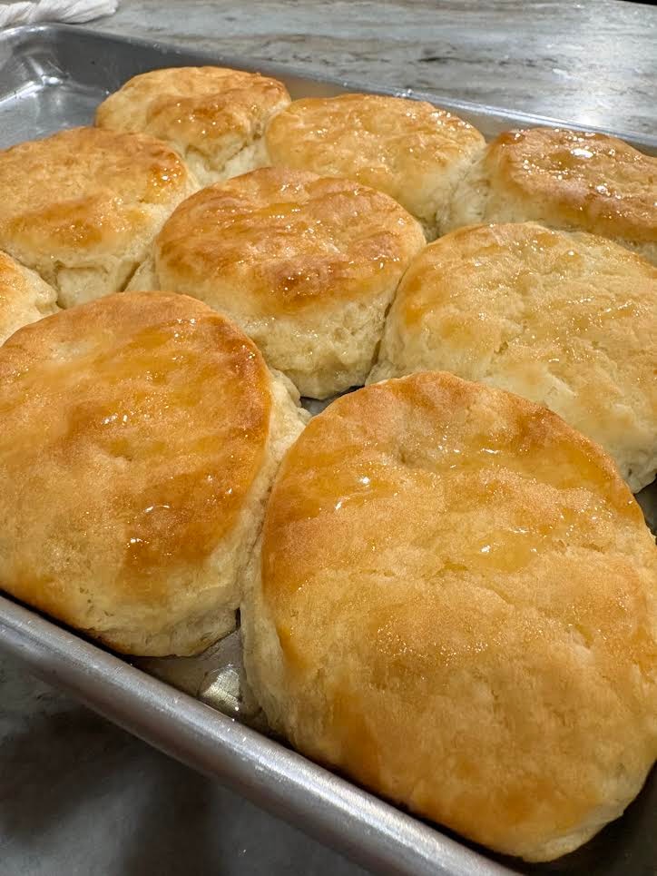 Golden buttery biscuits fresh from the oven in a baking pan