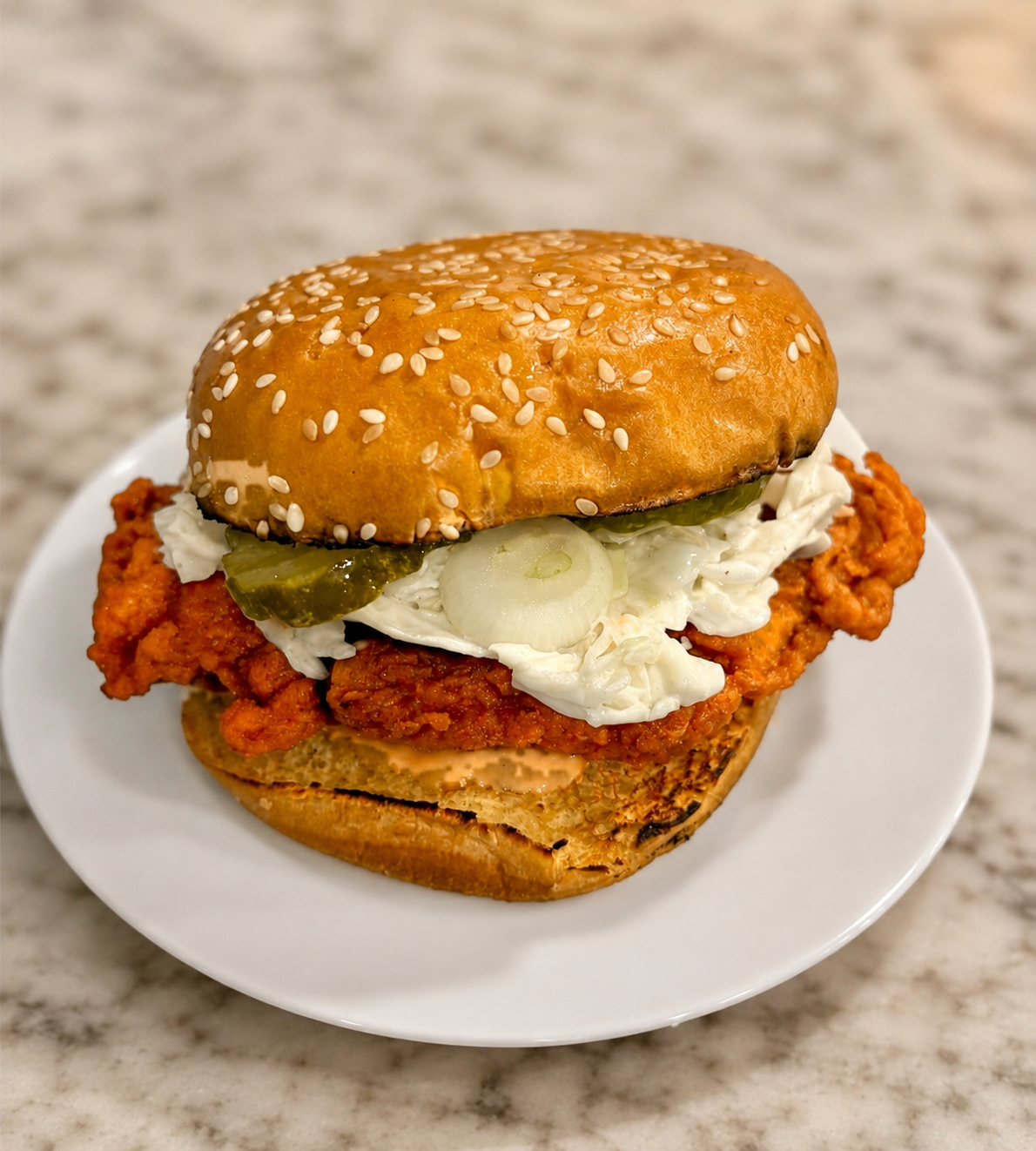 Hot chicken sandwich with coleslaw and pickles